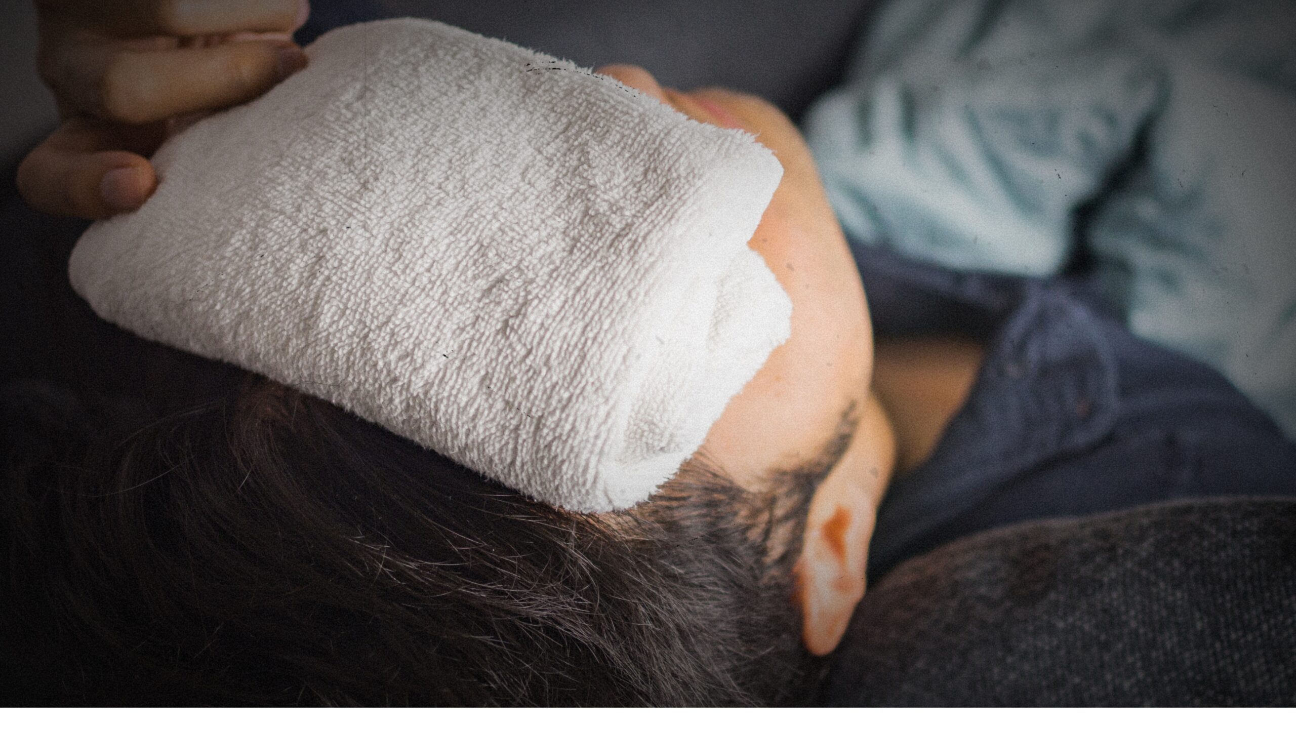 A person applying a warm compress to their eyes, demonstrating how to make a warm compress for eyes to relieve irritation and manage symptoms like ocular rosacea naturally.